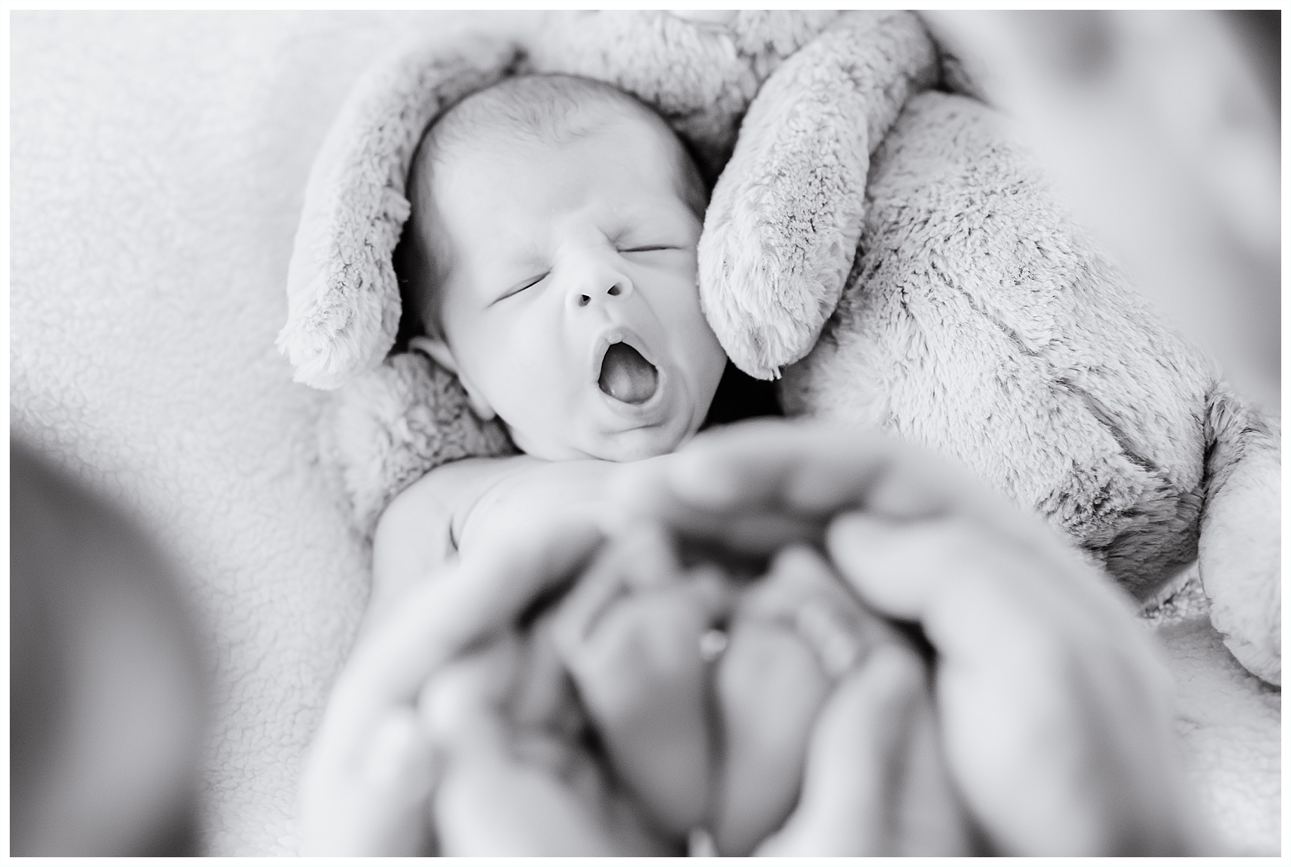 newborn baby girl yawning black and white