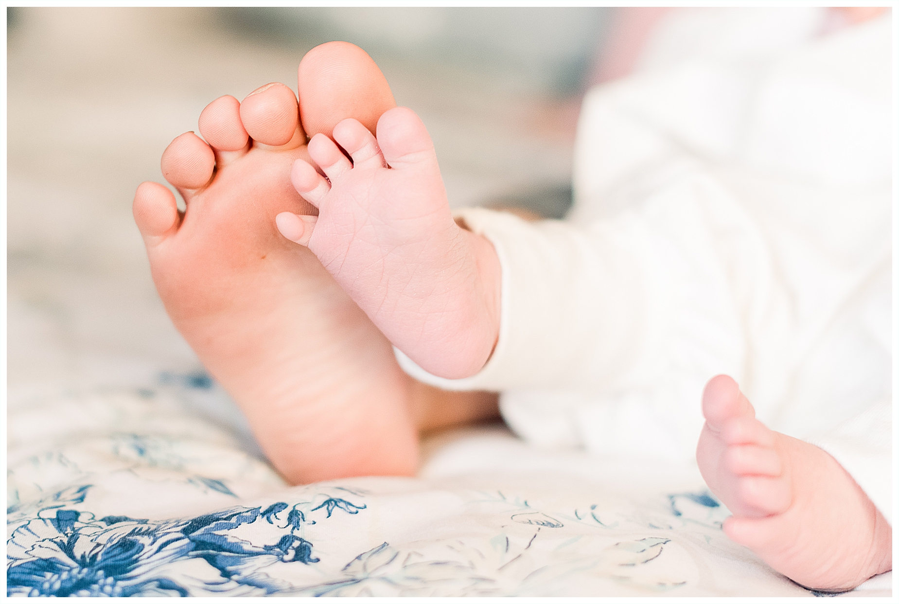 newborn baby girl feet with sibling