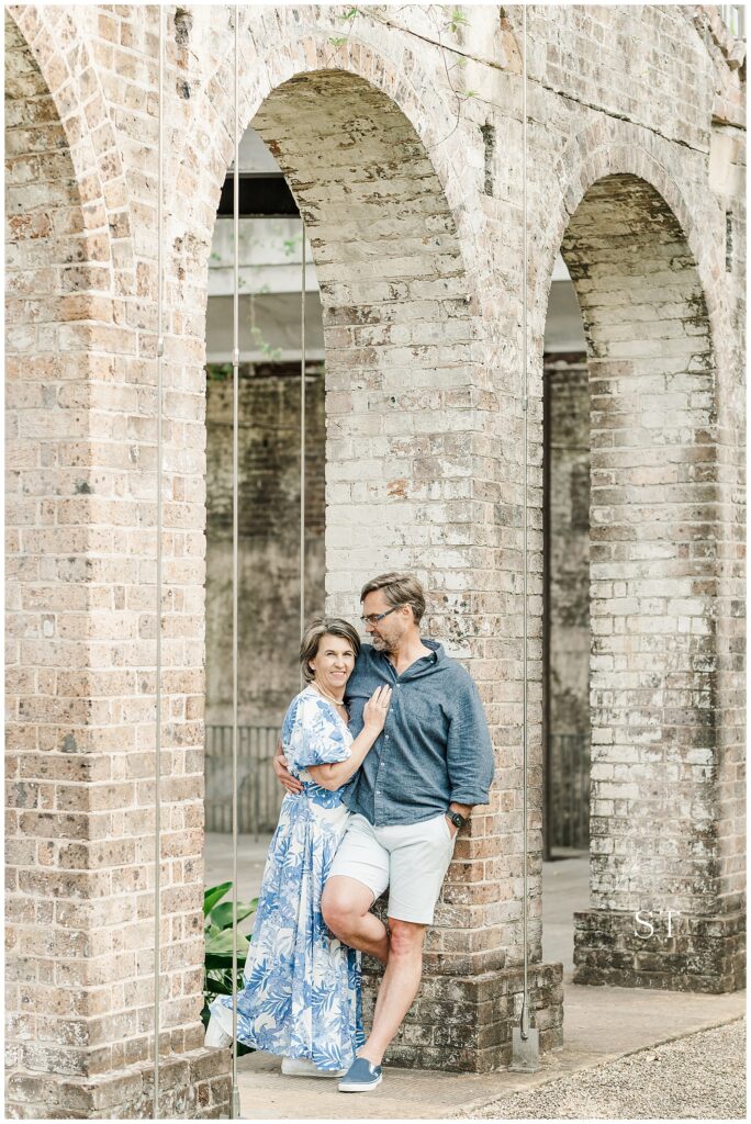 engaged couple in distressed brick archway. Engagement shoot

